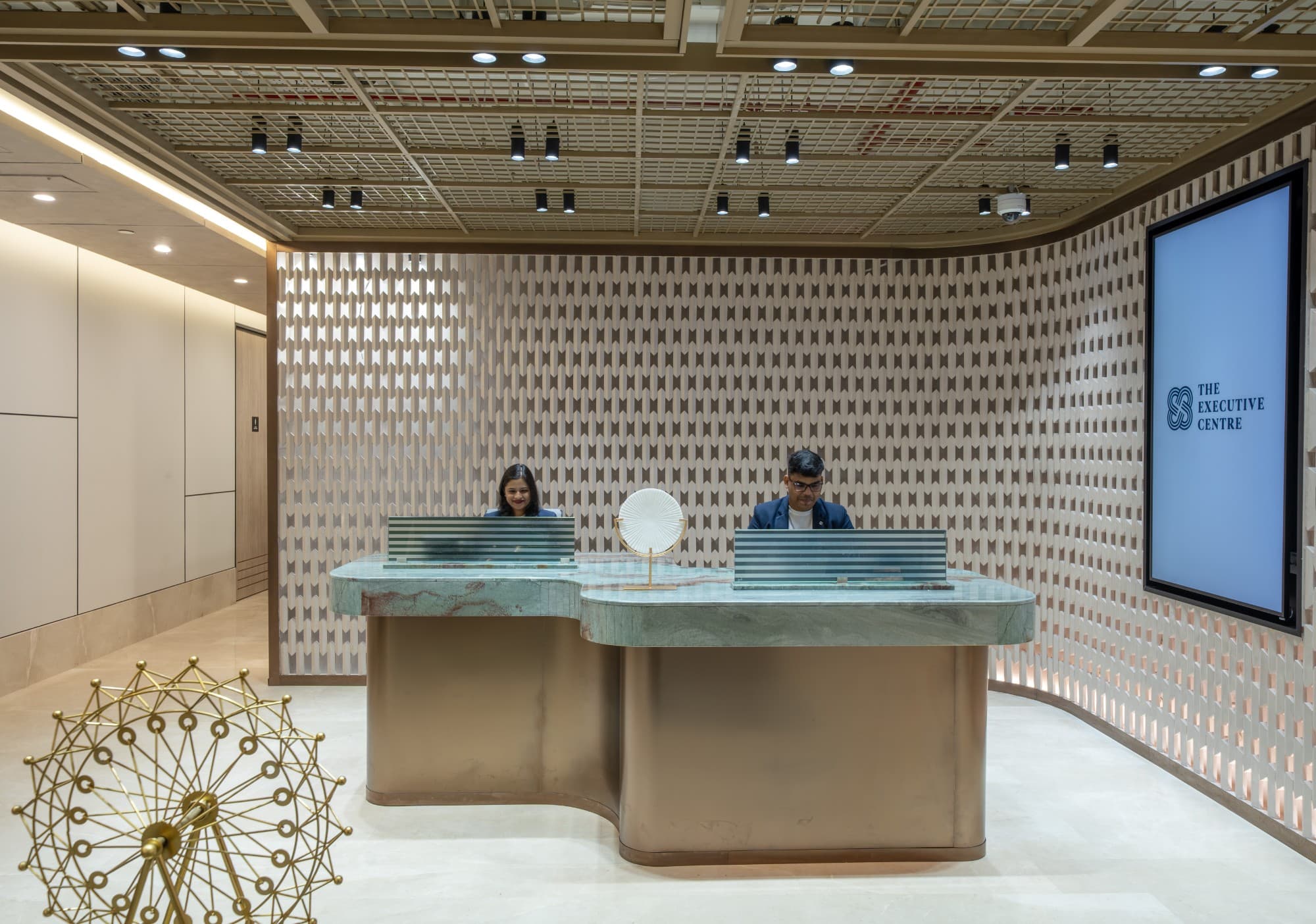 Reception area featuring modern furnishings and artwork at The Earth Centre in Bangalore