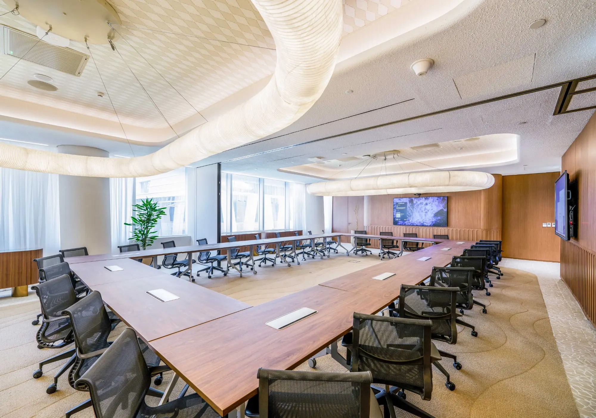 Premium Boardroom in KAFD 2.08 featuring modern furnishings and a large presentation screen